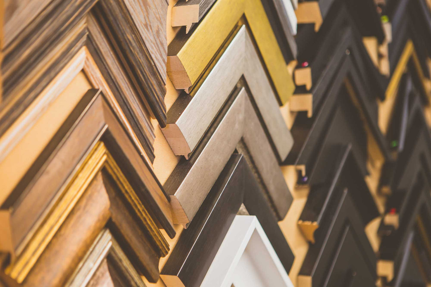 A salon-hang of framed work on the gallery wall at 64 South Street